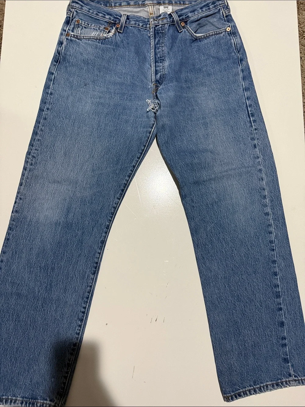 Levi's light blue denim jeans with tan leather patch